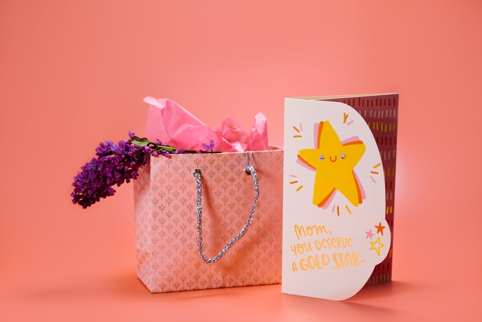 A Mother's Day gift bag and greeting card with purple flowers on a peach background.