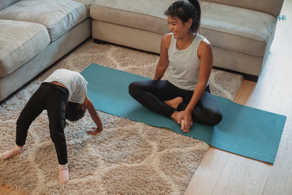 A mother and daughter enjoy a yoga session together on a cozy living room rug.