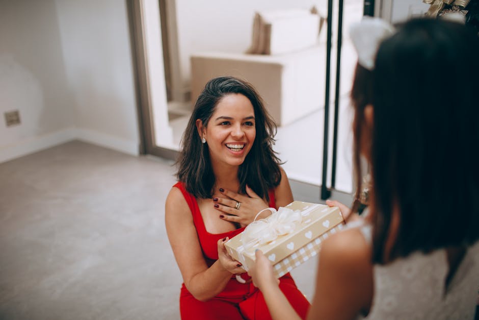 A joyful moment as a mother receives a gift from her daughter inside their home.