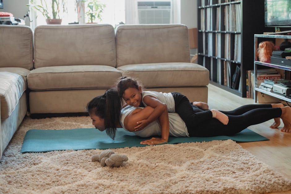 Side view of young Hispanic female athlete having fun with daughter while doing exercise