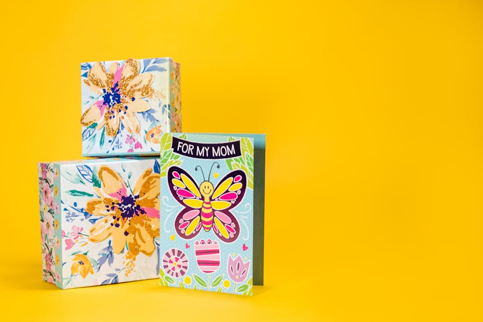 Cheerful Mother's Day card with butterfly design and vibrant floral gift boxes on yellow background.