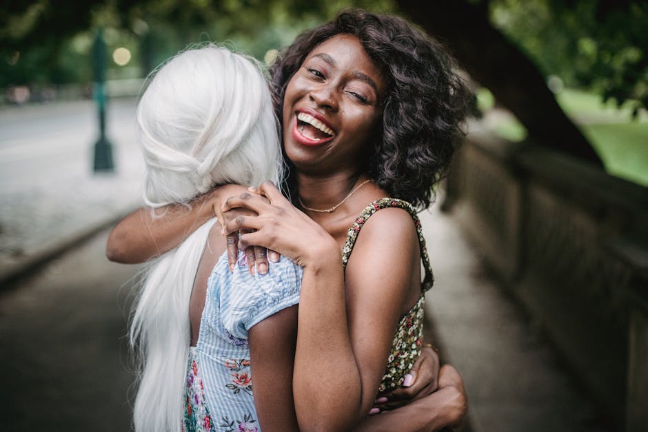 Two women sharing a happy embrace on a summer day outdoors.