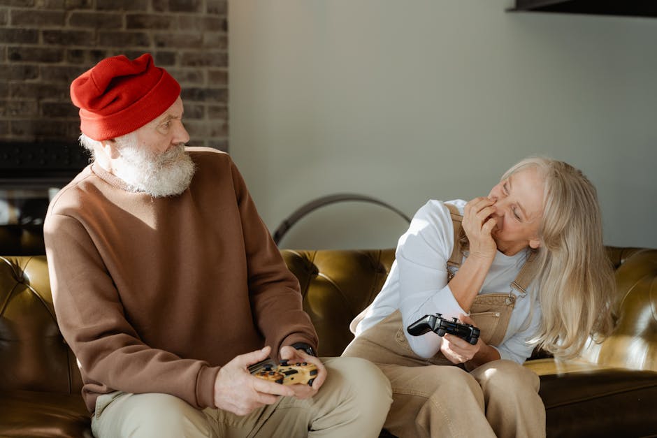 Elderly couple laughing and playing video games together on a cozy couch indoors.