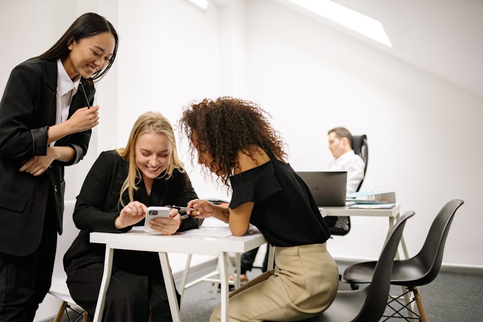 A group of diverse coworkers enjoying a moment together in a modern office setting, showcasing teamwork.