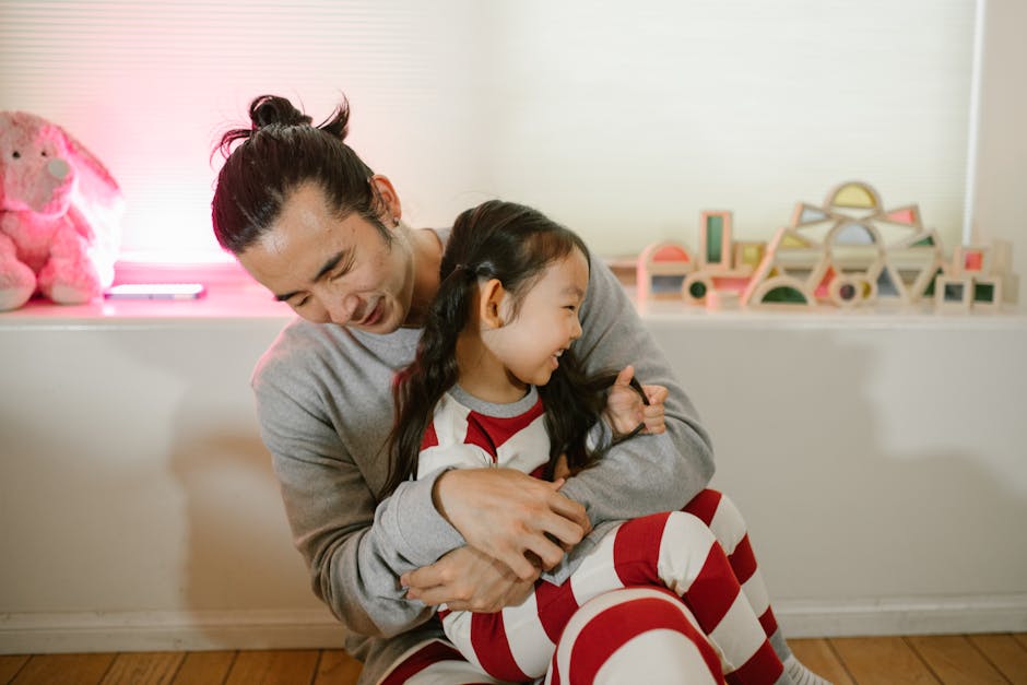 A joyful father and daughter spending quality time and laughing together indoors.