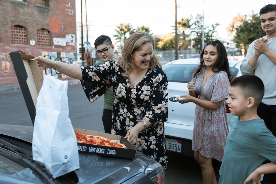 Happy family enjoying a pizza outing together in an urban setting.
