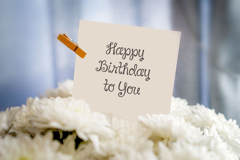 A birthday card with 'Happy Birthday to You' text amidst white flowers for a cheerful celebration.