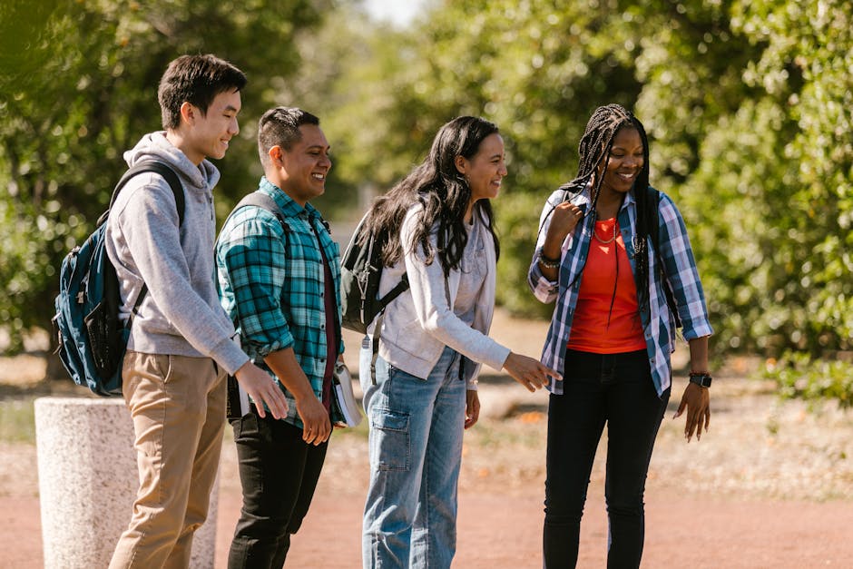 Cheerful group of diverse students chatting outdoors with backpacks. Perfect for education and lifestyle themes.