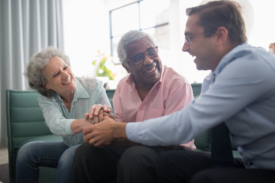 A warm interaction between a diverse group of adults inside a well-lit room.