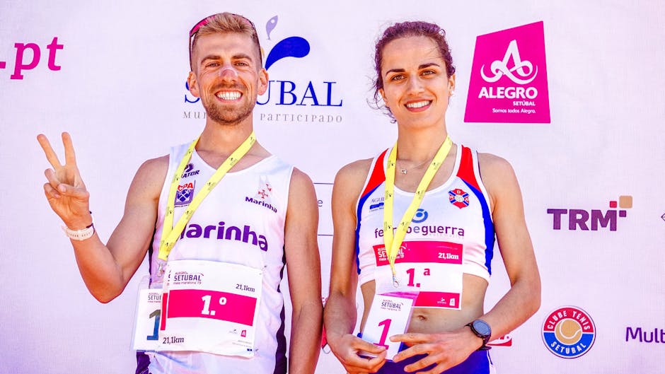 Happy marathon winners celebrating victory at outdoor Setúbal event.