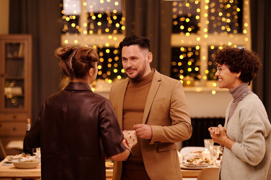 Adults enjoying a Christmas celebration with gift giving surrounded by festive décor.