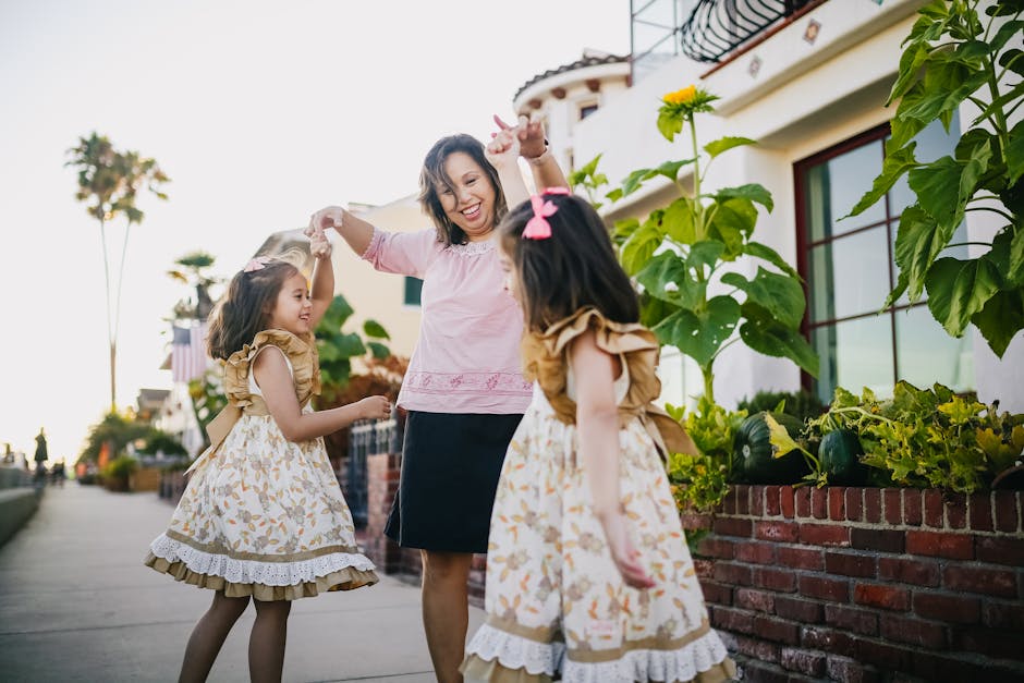 A loving mother dances with her twin daughters on a sunny day, capturing the joy of family togetherness and happiness.
