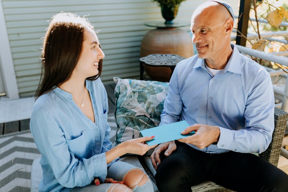 A father and daughter exchange a card in a warm and happy setting, symbolizing love and togetherness.