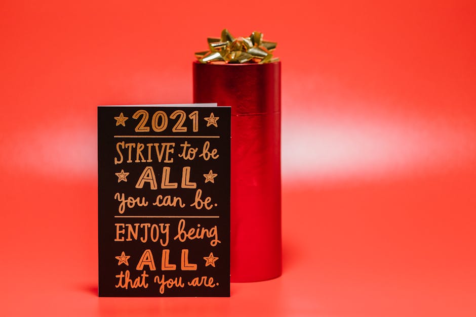 Greeting card with motivational message and gift box on a vibrant red background.