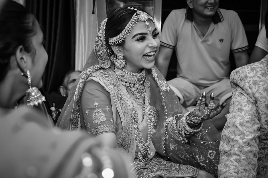 A candid moment of a laughing bride in traditional Indian clothing. Captured in black and white.