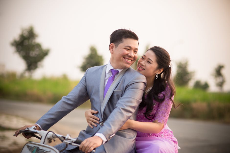 Bride and groom enjoying a romantic moment on a bicycle outdoors.