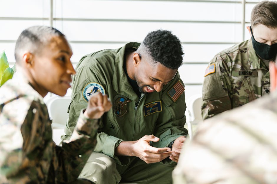 US military veterans engaging in a light-hearted group therapy session indoors.
