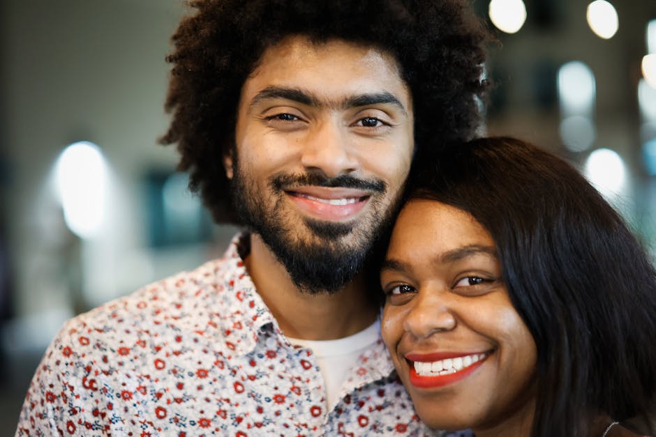 A joyful couple smiling together, capturing positive energy and affection.