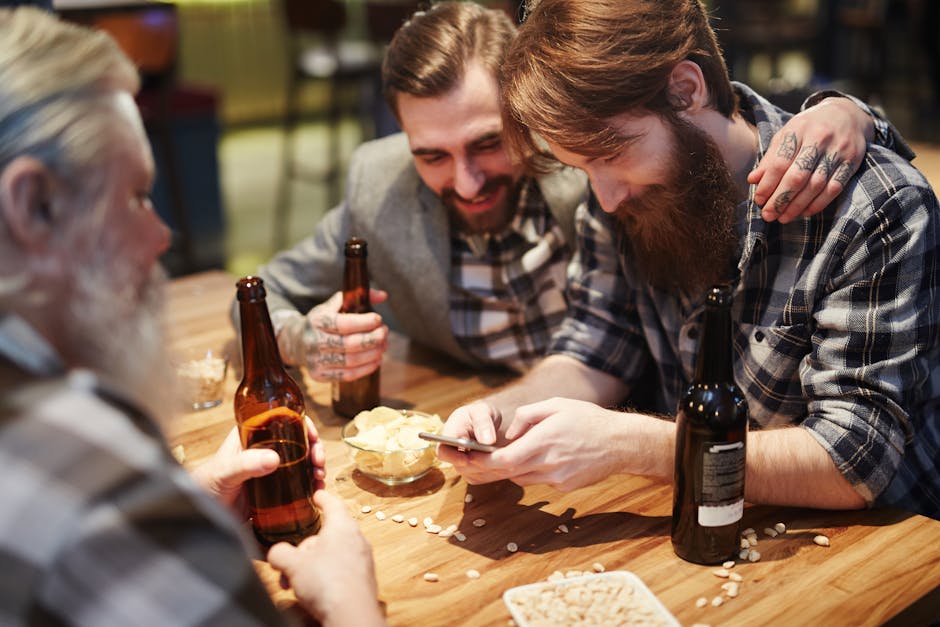 Group of men enjoying a friendly hangout at a pub, sharing beers and snacks.