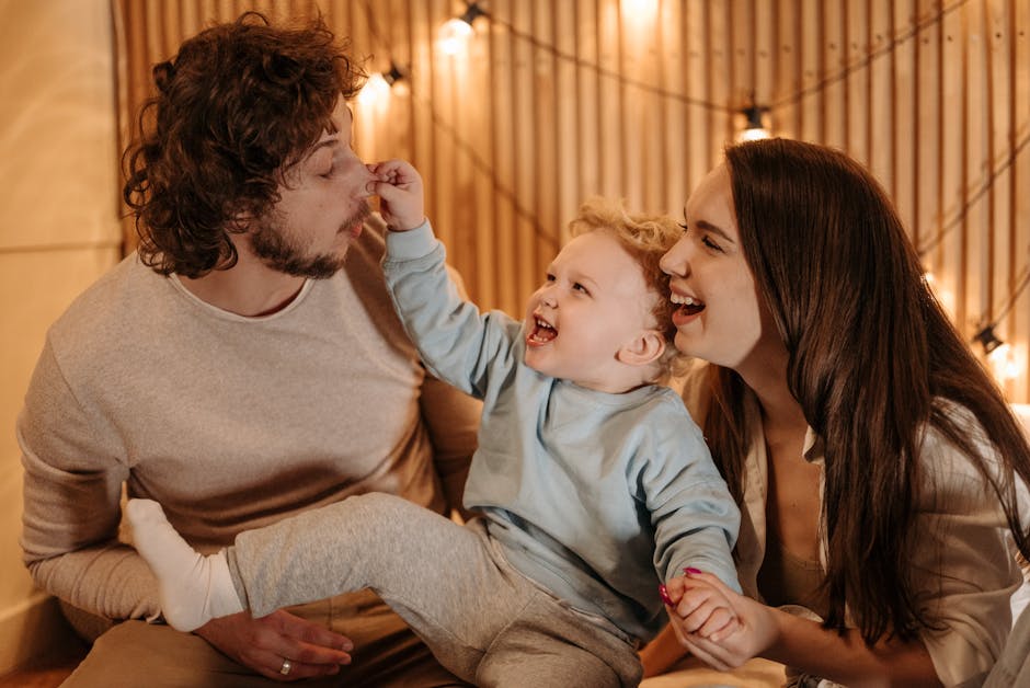 Happy family bonding time with parents and child laughing indoors.