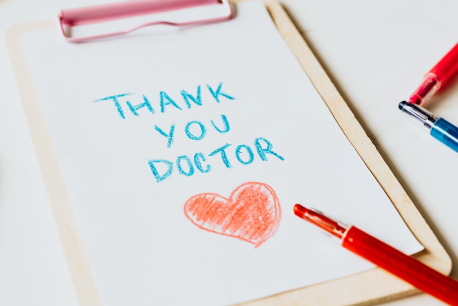 Handwritten thank you note for doctor with a heart drawing on paper.