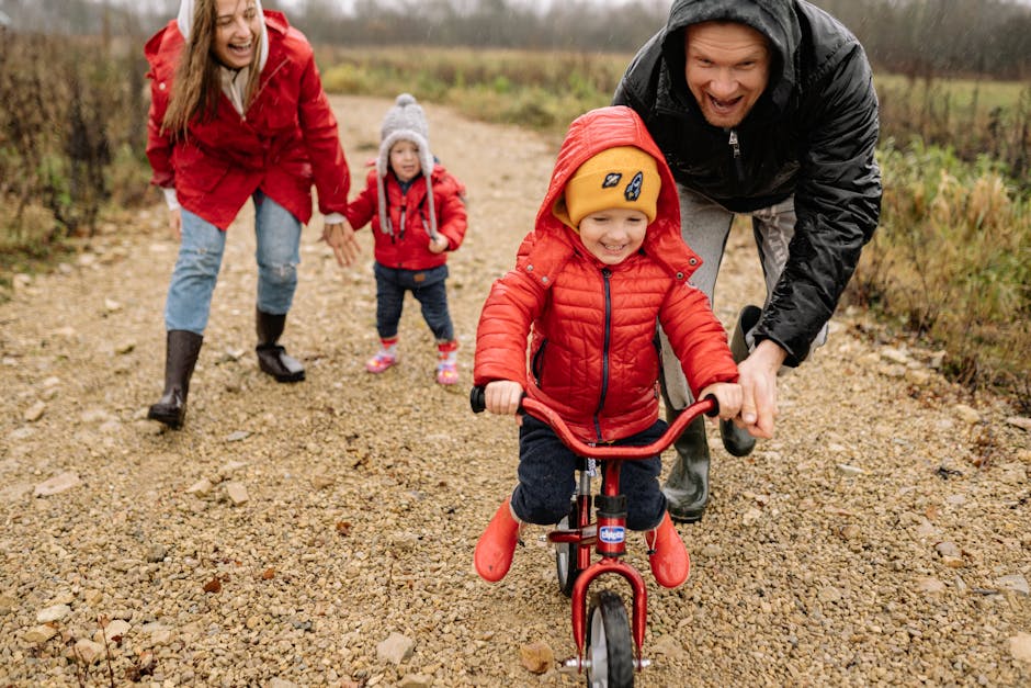 Parents teaching kids to ride bikes outdoors in fall, enjoying family bonding and fun.