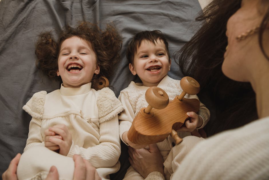 Happy family bonding time featuring a mother and her children enjoying a playful moment together indoors.