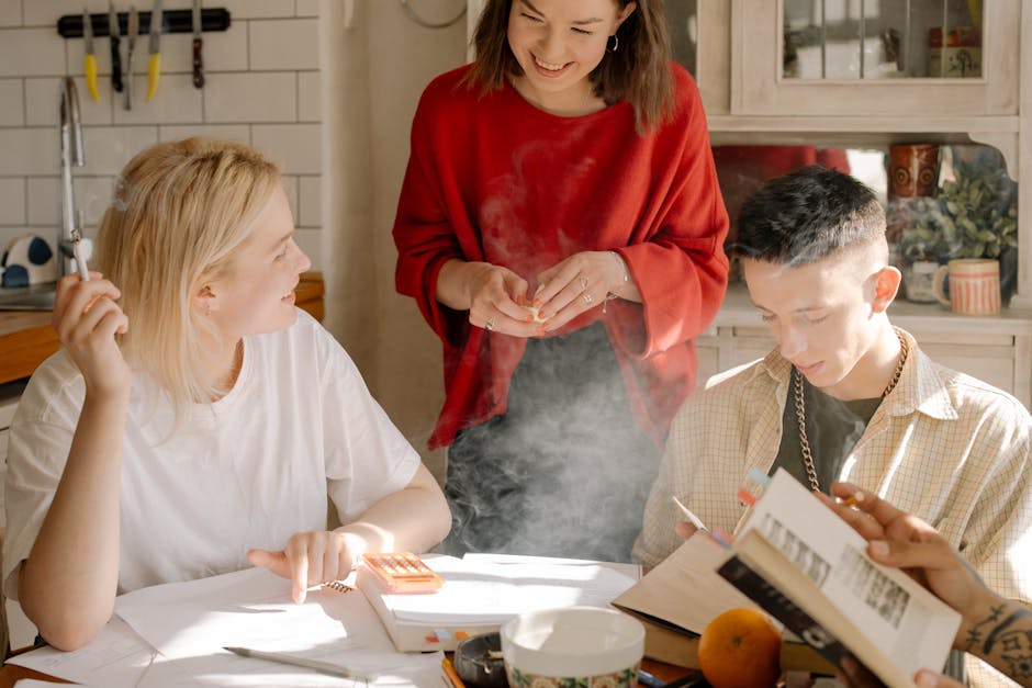 Young adults enjoying leisure time and conversation in a cozy kitchen environment.