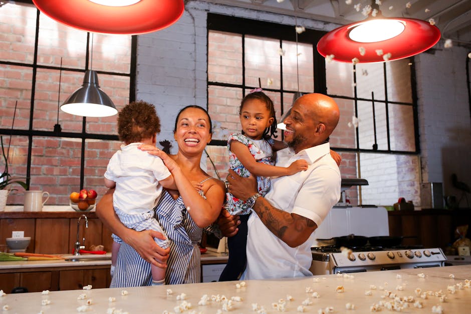 A joyful family of four spending quality time in a cozy kitchen setting.