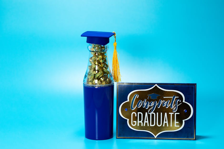 Graduation-themed gift with a congrats card and a blue graduation cap tumbler on a vibrant blue background.