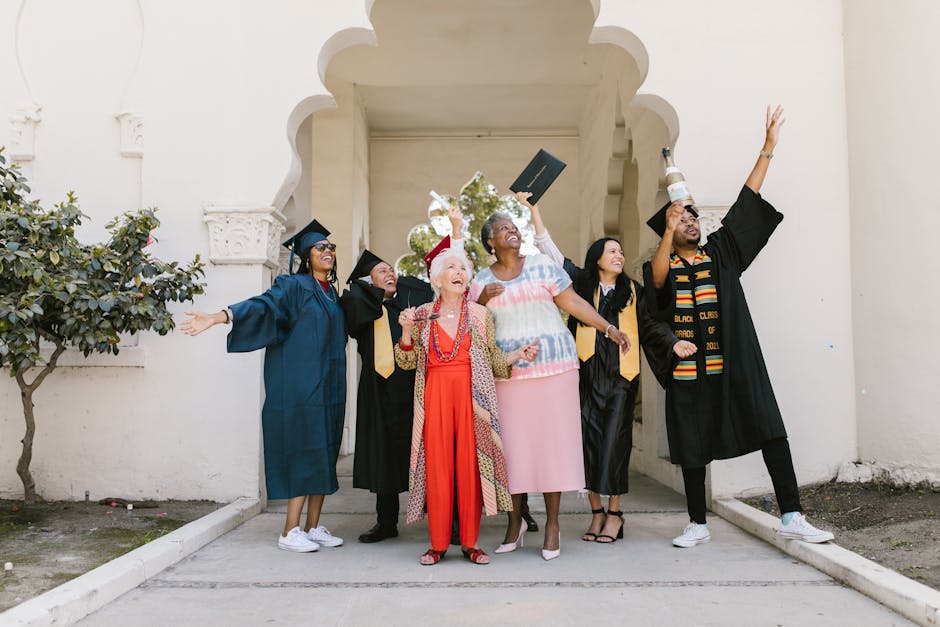 Graduates and family celebrating outdoors, expressing joy and success.