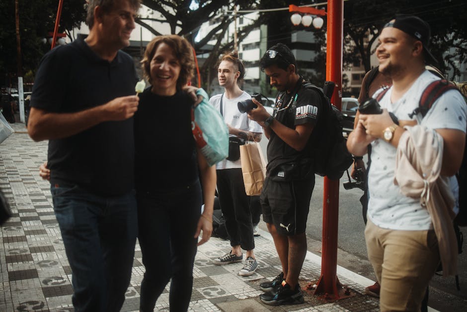 Candid street photo of a group interacting with photographers capturing the lively moment.
