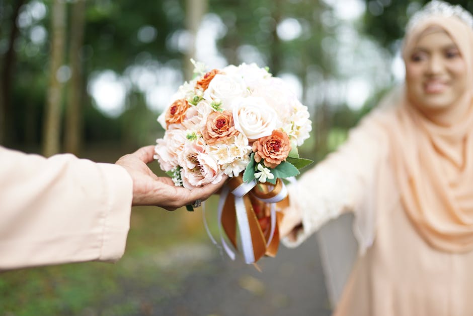 A bride exchanges a colorful bouquet outdoors in Taiping, Malaysia.
