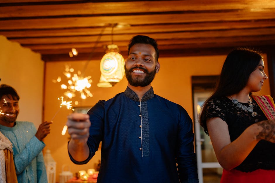 A joyous Diwali celebration with a group holding sparklers and smiling in vibrant attire.