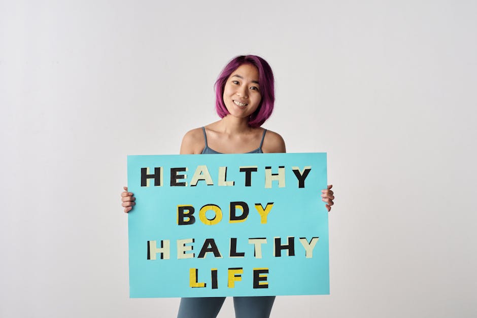 A young woman with purple hair holding a poster promoting a healthy lifestyle.