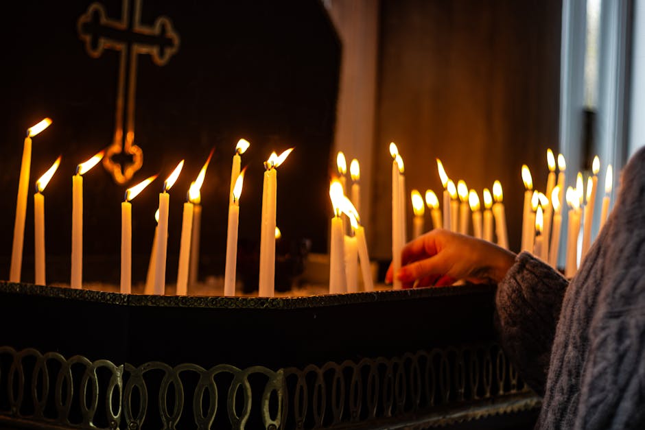 A reflective moment with lit candles inside a church, conveying warmth and spirituality.