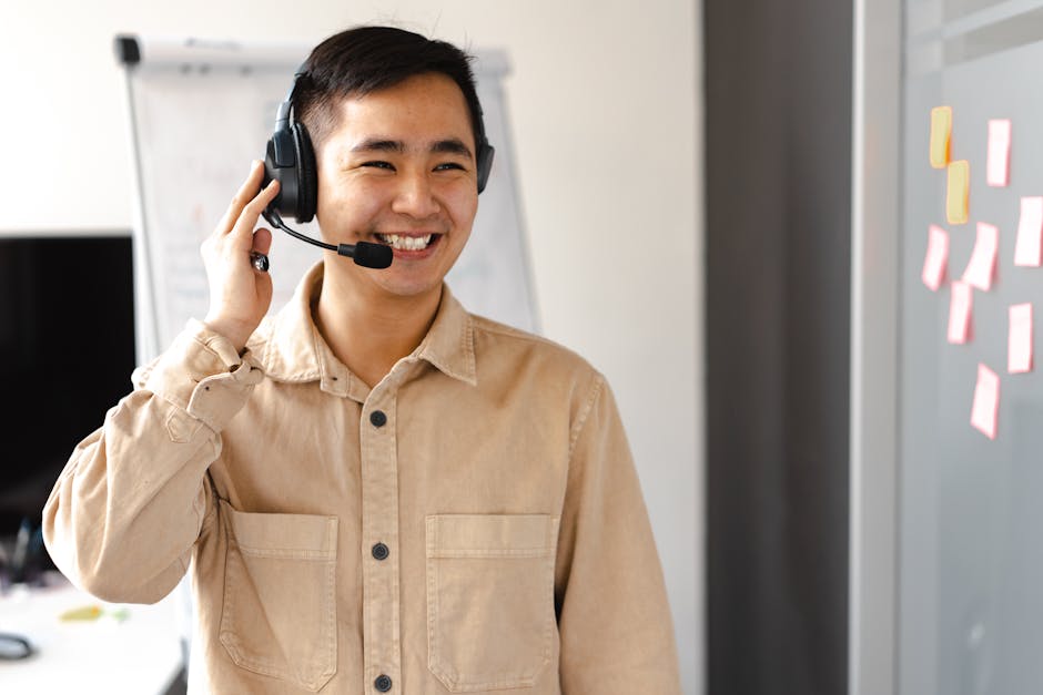 Friendly call center agent smiling during a call in an office setting.
