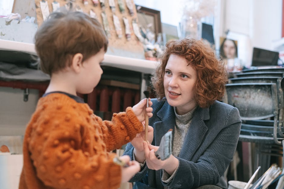 A mother and child bonding over art, sharing creativity in an indoor studio setting.
