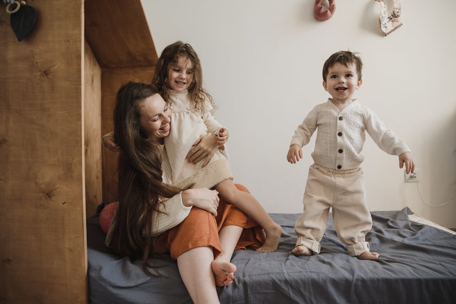 A joyful mother spending quality time with her children on a bed, creating precious memories.