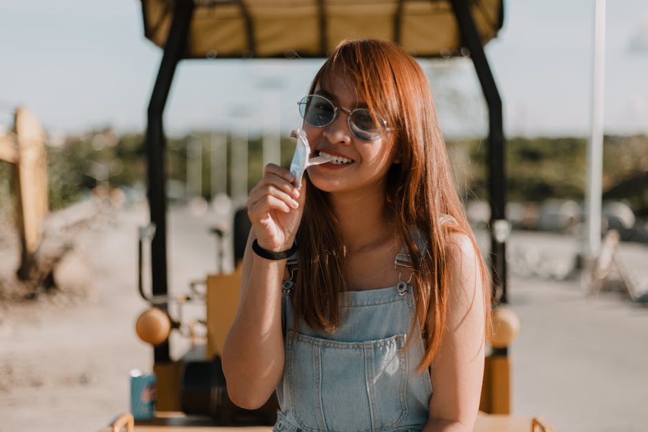 A happy young woman enjoying outdoors with a joyful smile and casual style.