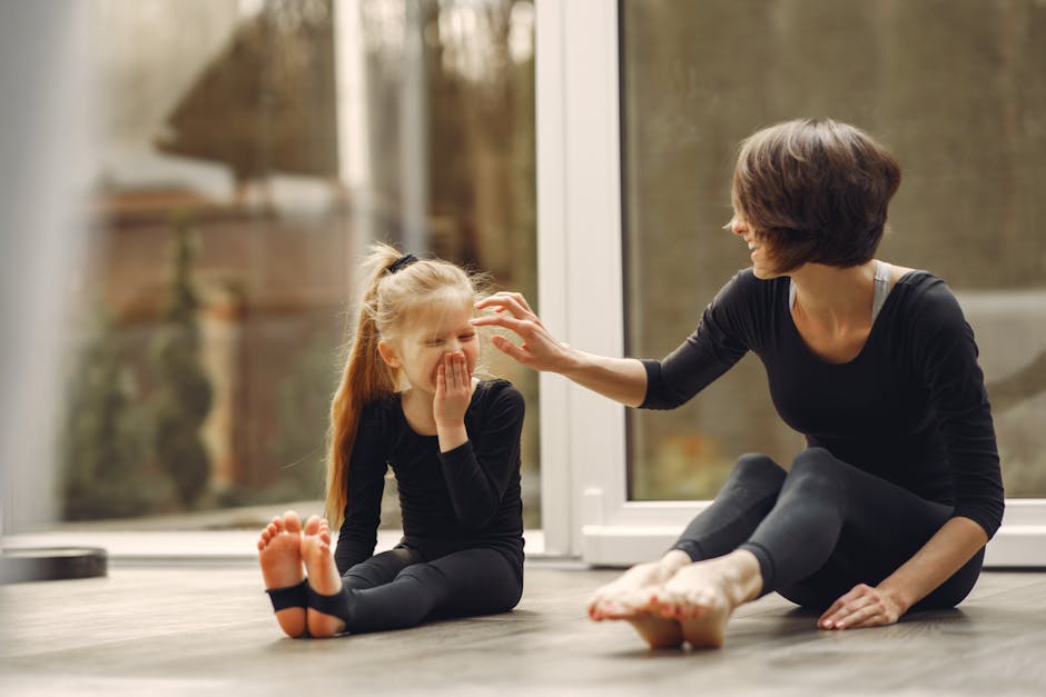 A mother and daughter bonding through yoga exercises, showcasing happiness and togetherness.