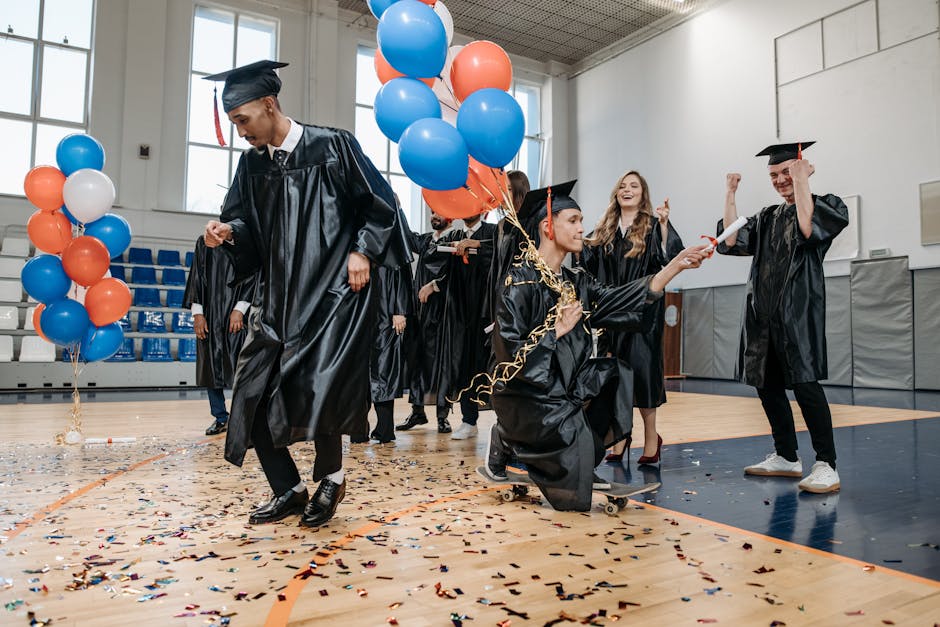 Graduates celebrating with balloons and confetti indoors, exuding happiness and success.