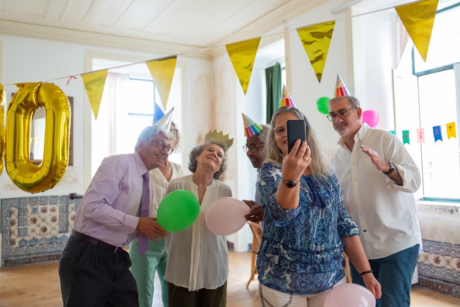 A group of seniors having fun at a birthday celebration, capturing the moment with a selfie.