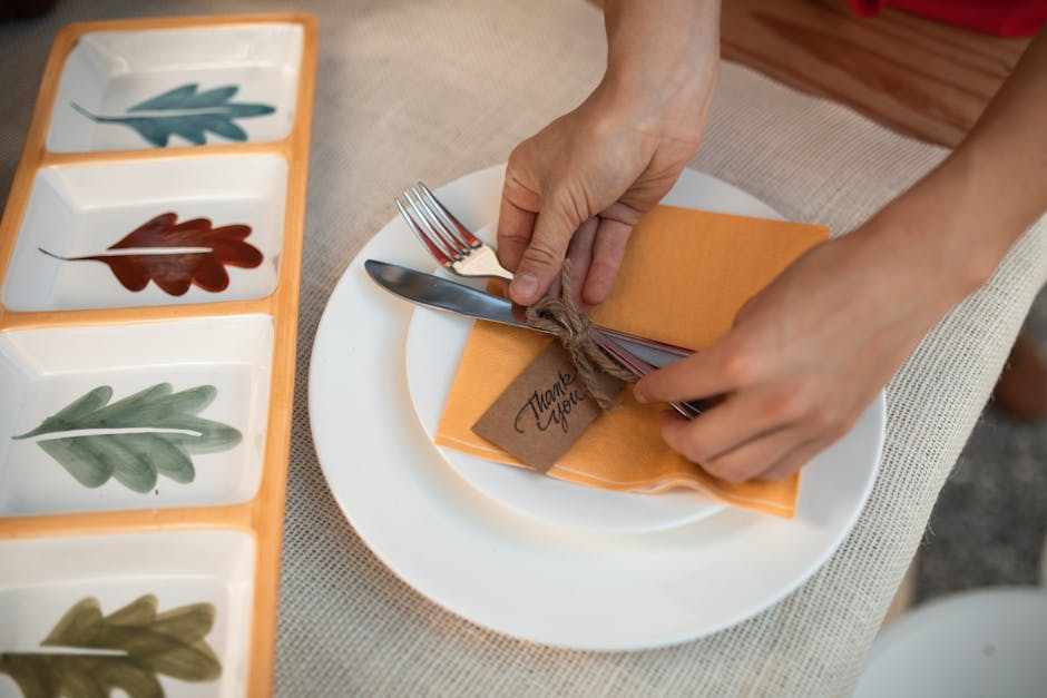 Elegant autumn table setting with cutlery wrapped in a thank you card.