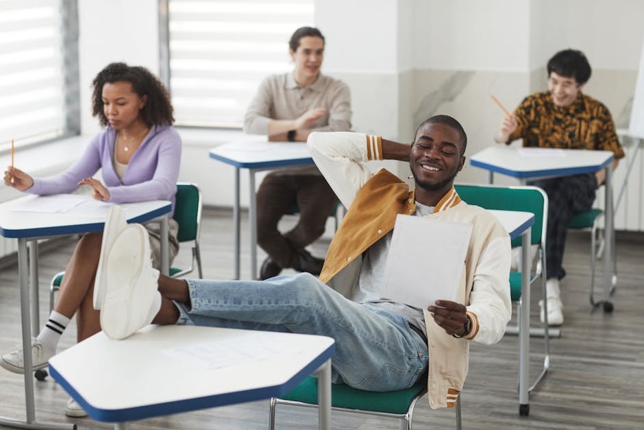 Diverse group of cheerful students taking an exam in a modern classroom.