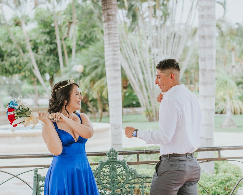 A couple shares a playful moment during a photoshoot at a lush park in Guayaquil, Ecuador.