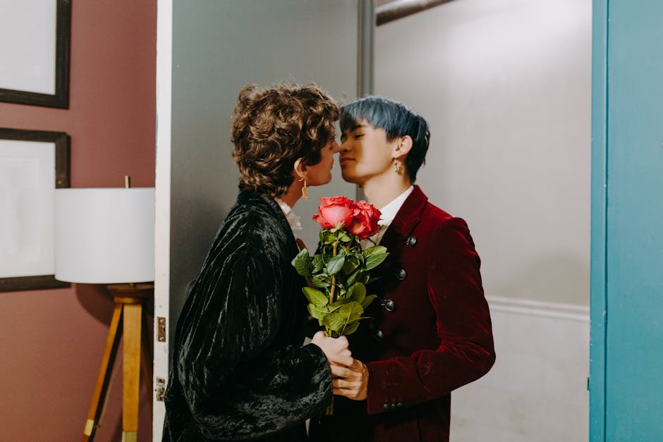 Couple sharing an intimate moment with roses in a doorway, expressing love.