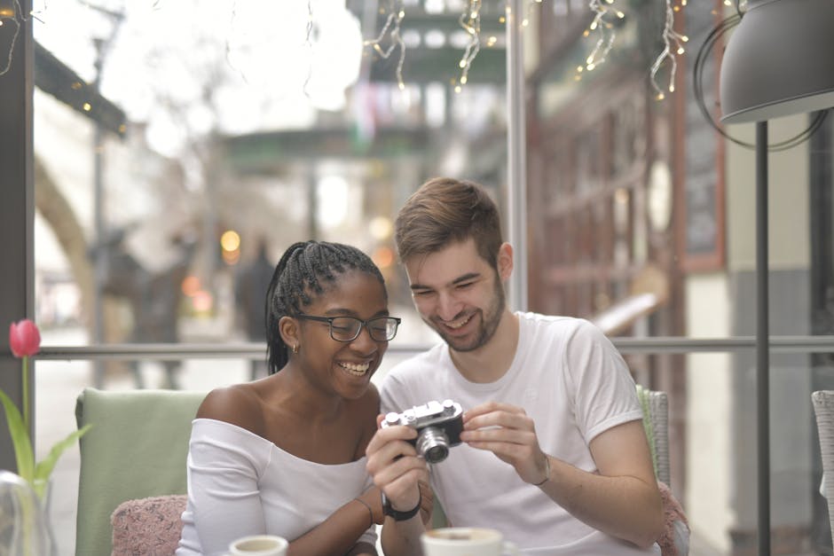 Smiling couple sharing a joyful moment inside a cozy cafe setting.