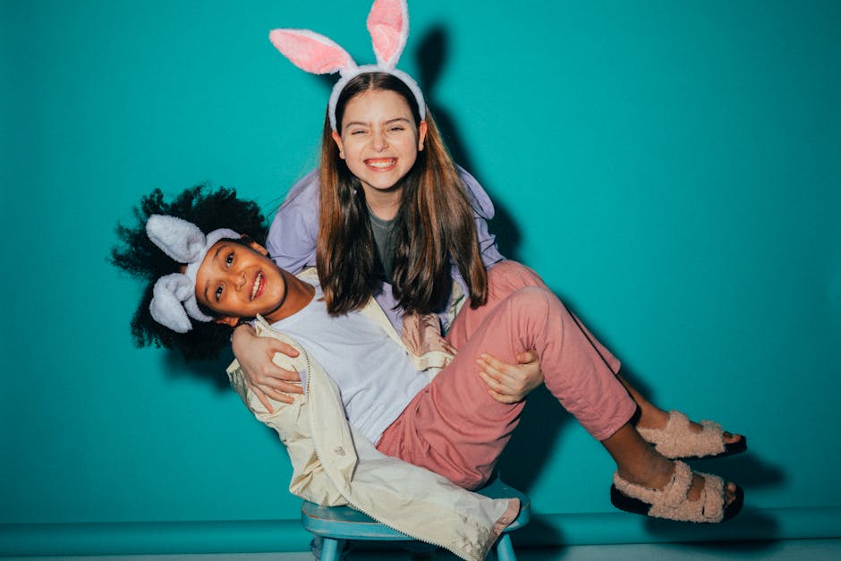 Two playful children wearing bunny ears enjoying a fun moment together indoors.