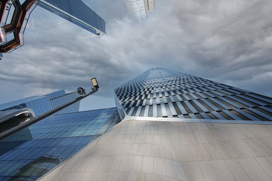 A low angle view of a towering modern skyscraper highlighting architecture in New York City.